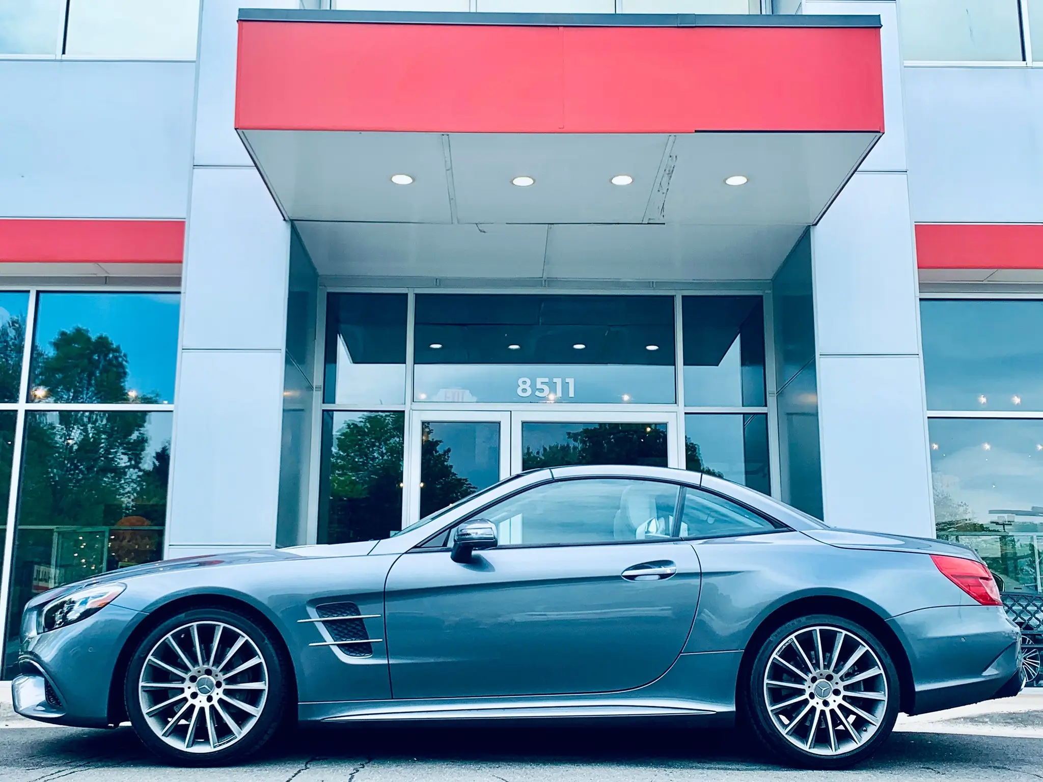 Vehicle being loaded onto transport truck for nationwide delivery from VINS Cars